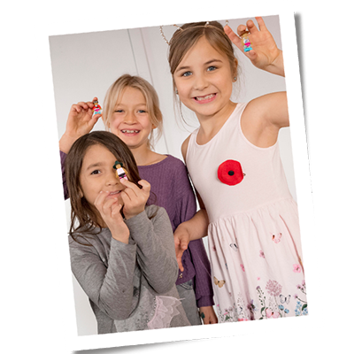 Kids smiling and holding LEGO creations